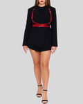 ed leather harness styled over a black blazer and shorts