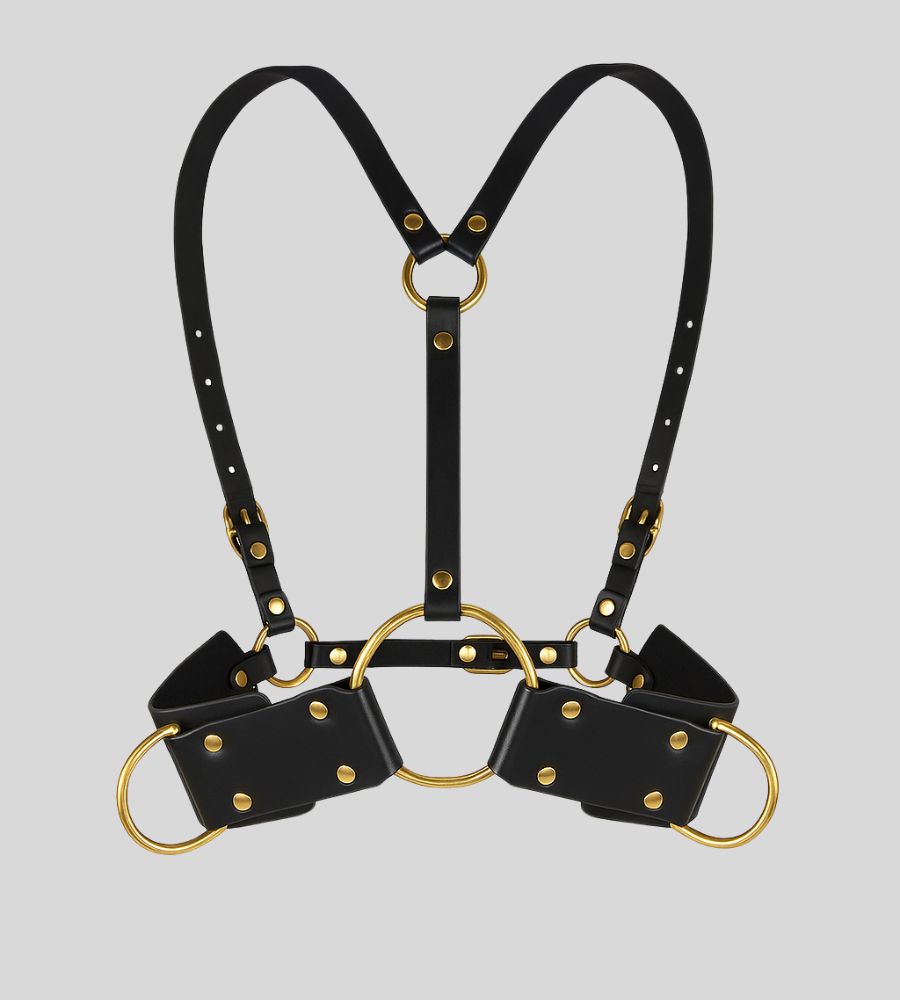 front view of black leather body harness with gold O-rings