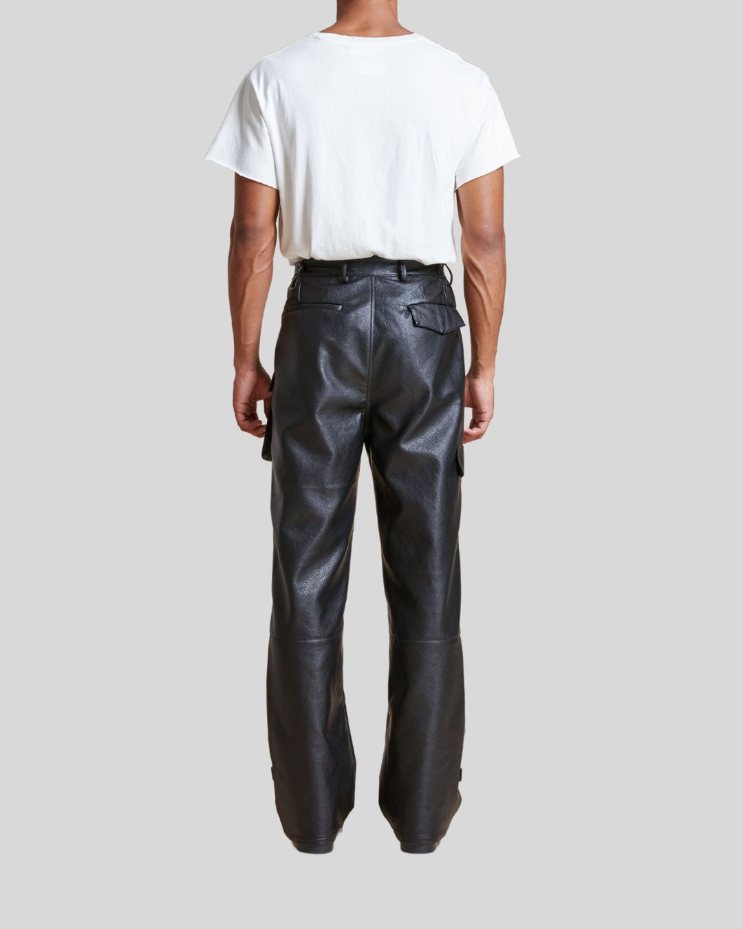  back view of black leather cargo pants on model – Night Ops
